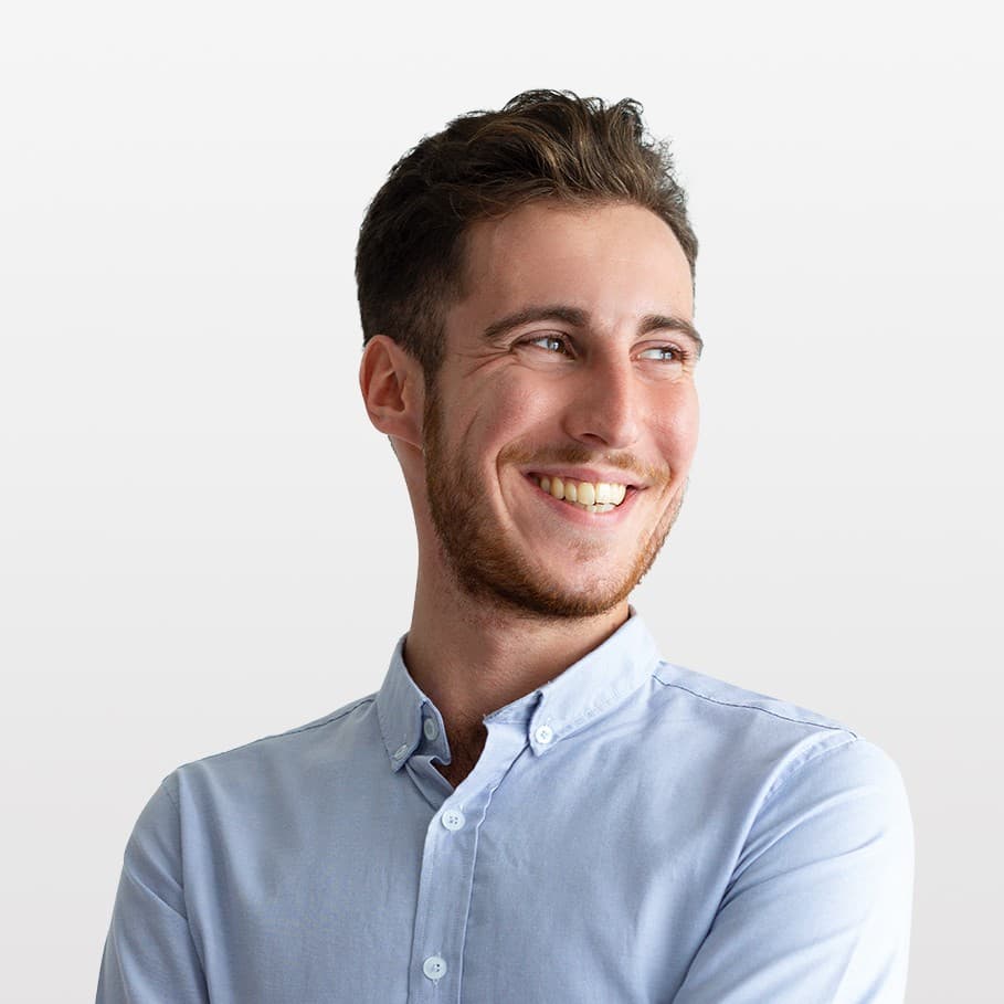 man with short blond hair, beard and mustache, smiling, in a blue shirt